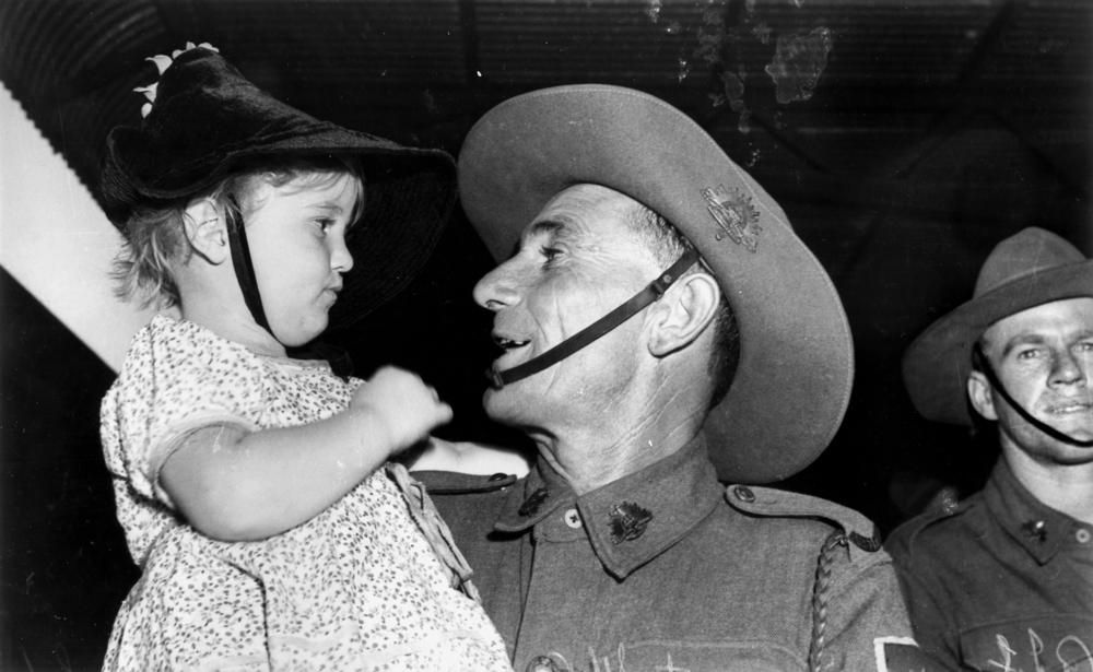 Glenis Anderson welcomes her father Clark home from the war, Brisbane, February 1940